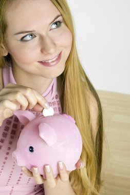 Woman with a piggy bank clipart