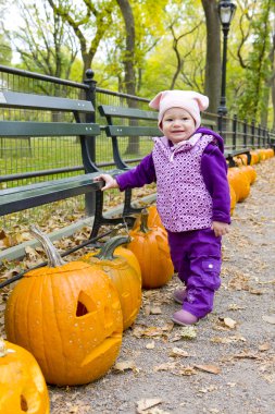 Toddler with pumpkins clipart