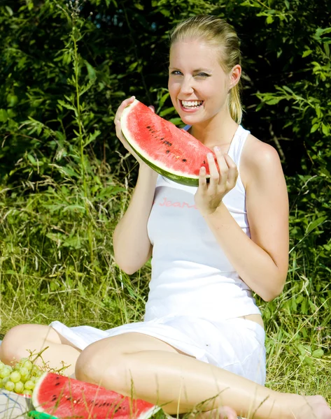 Woman with melon at a picnic — Stock Photo, Image