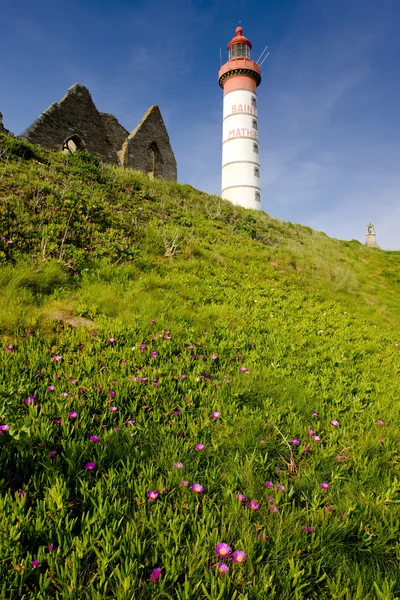 Lighthouse and ruin of monastery — Stock Photo, Image