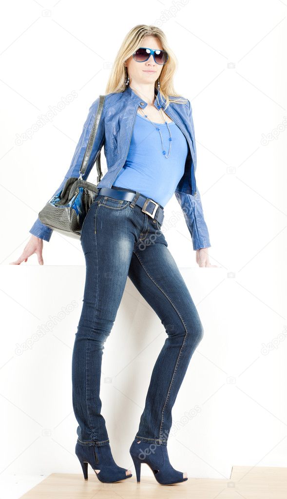 Woman wearing blue clothes with handbag