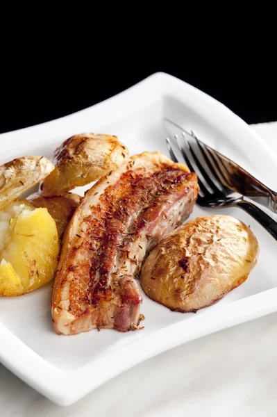 Roasted pork meat with potatoes — Stock Photo, Image