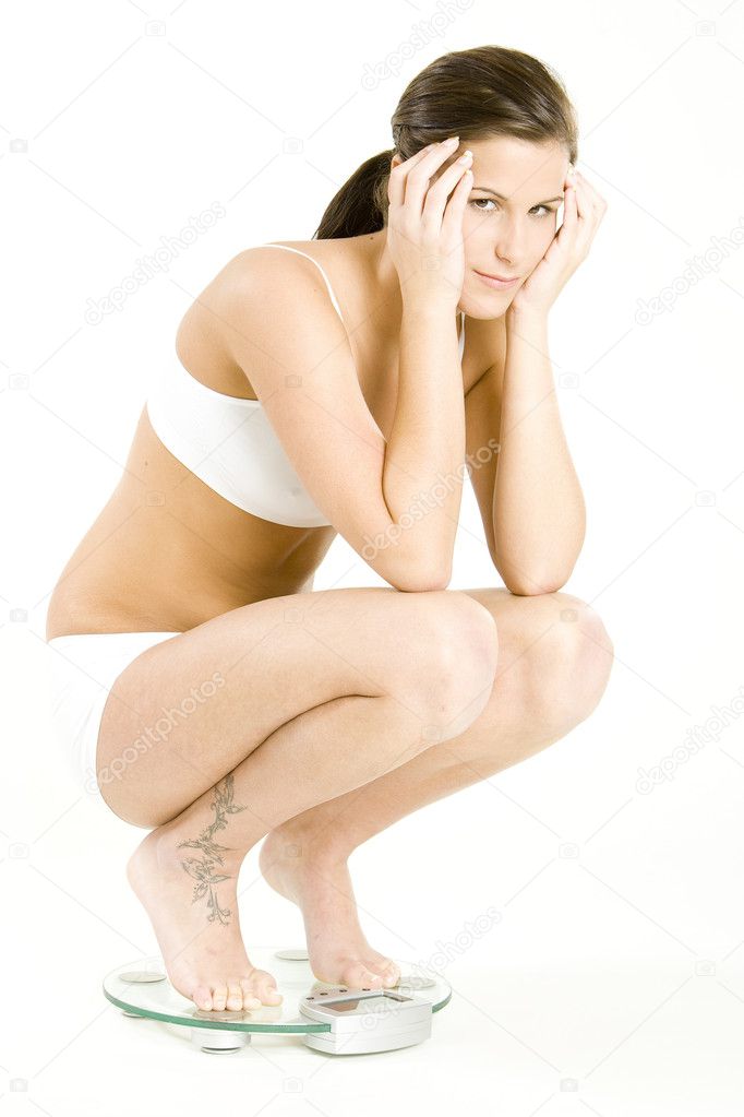 Woman wearing underwear on weight scale