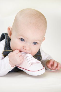 Baby girl holding a shoe clipart