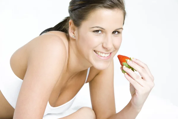 Woman with a strawberry — Stock Photo, Image