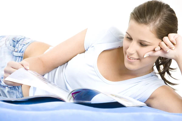 Portrait of lying down woman with a journal — Stock Photo, Image