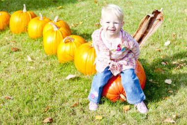 Little girl with pumpkins clipart