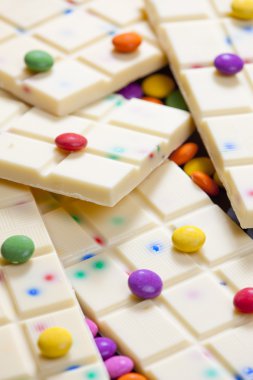 Still life of white chocolate with smarties clipart