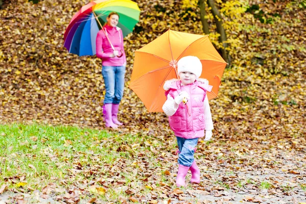 Mutter und Tochter mit Regenschirmen in herbstlicher Natur — Stockfoto