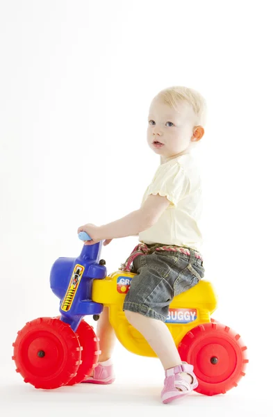 stock image Little girl on toy motorcycle