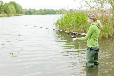 Woman fishing in pond clipart