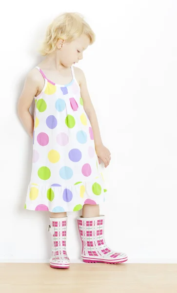 Little girl wearing dress and rubber boots — Stock Photo, Image