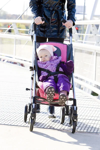 Woman with toddler sitting in pram on walk — Stok fotoğraf
