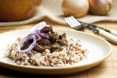 Pork kidney on onion with wild rice clipart