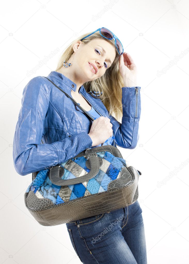 Woman wearing blue clothes with handbag