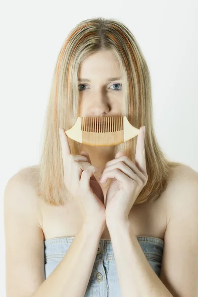 Woman holding a comb — Stock Photo, Image