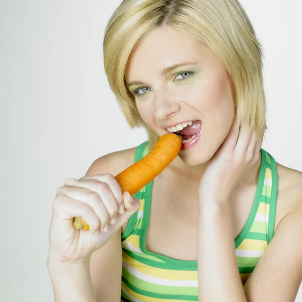 Woman with a carrot — Stock Photo, Image