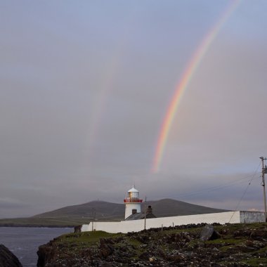 Lighthouse with rainbow, The Mullet Peninsula, County Mayo, Irel clipart