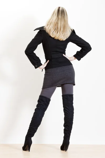 Standing woman wearing fashionable black boots — Stock Photo, Image