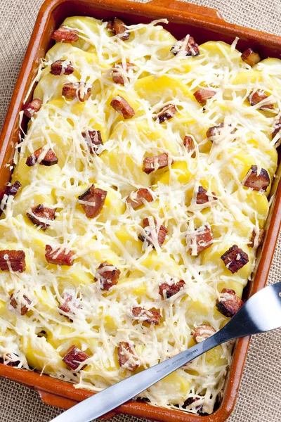 Potatoes and bacon baked with pecorino cheese — Stock Photo, Image
