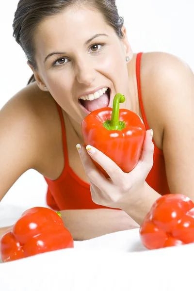 Portrait of lying down woman with peppers — Stock Photo, Image