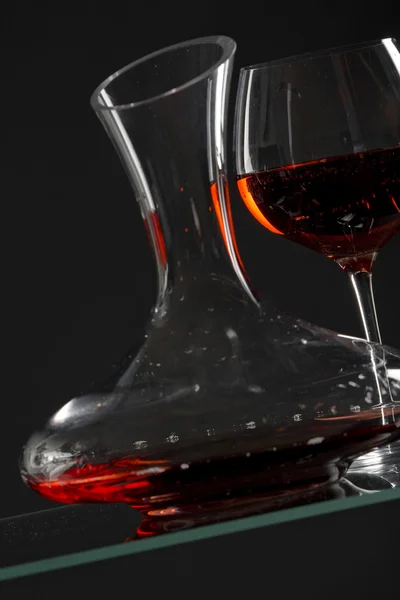 Wine glass and carafe with red wine