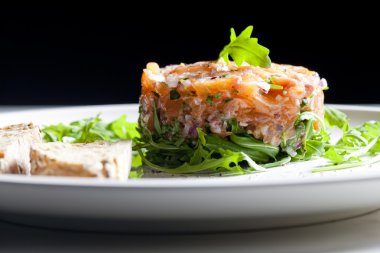 Salmon tartare with ruccola clipart