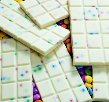 Still life of white chocolate with smarties clipart