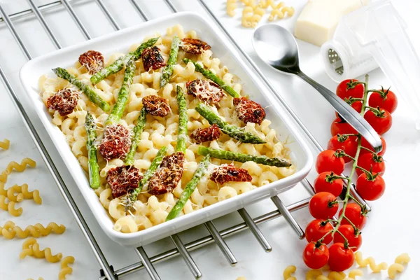 stock image Pasta baked with dried tomatoes, asparagus and pecorino cheese