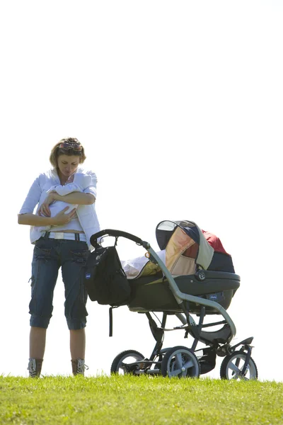 Woman with baby and pram — Stock Photo, Image