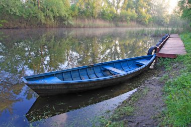 Blue boat on river clipart