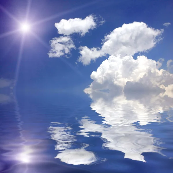 Star in the blue sky over water — Stock Photo, Image