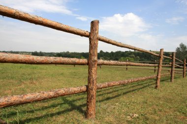 Wooden fence on meadov clipart