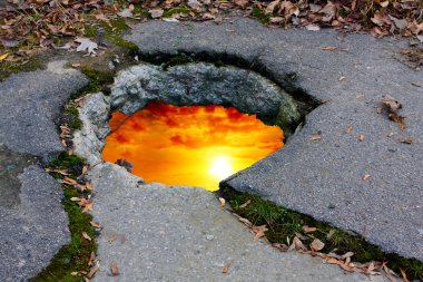 Sunset on hole in road clipart