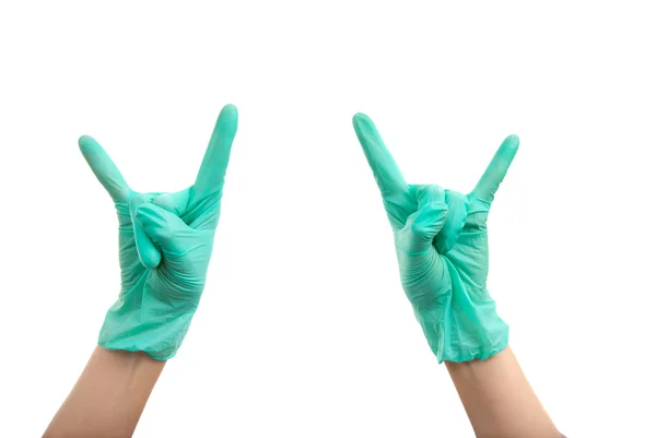Las manos en los guantes quirúrgicos hacen corna —  Fotos de Stock
