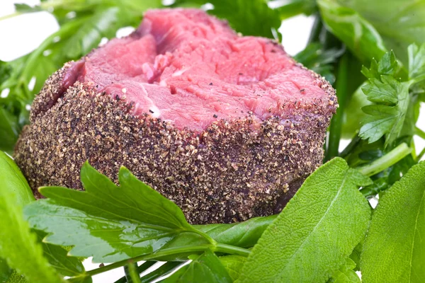 stock image Raw fillet steak on mixed herbs