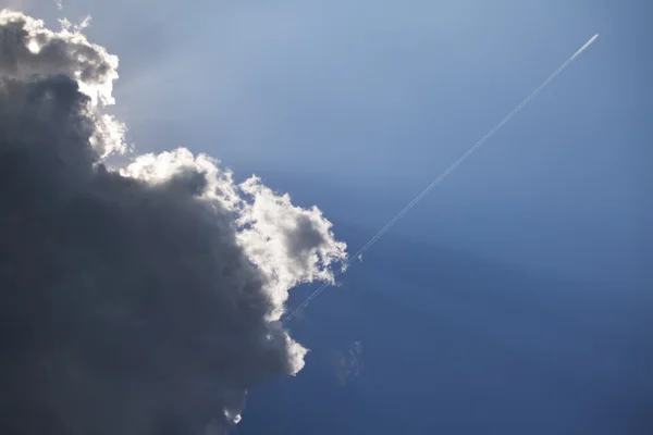 stock image Jetplane escaping a dark cloud