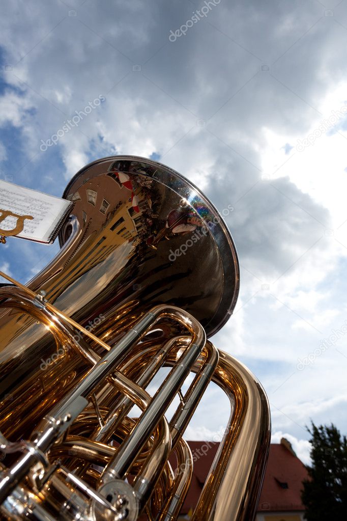 Brass tuba outdoors on a cloudy day
