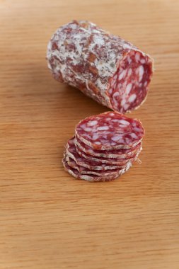 Slices of an a italian salami on an oak table