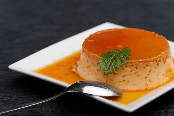 Creme caramel on a square plate — Stock Photo, Image