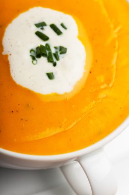 Pumpkin soup in a white bowl clipart