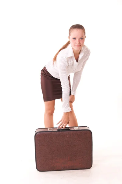 Young female model picking up large suitcase — Stock Photo, Image