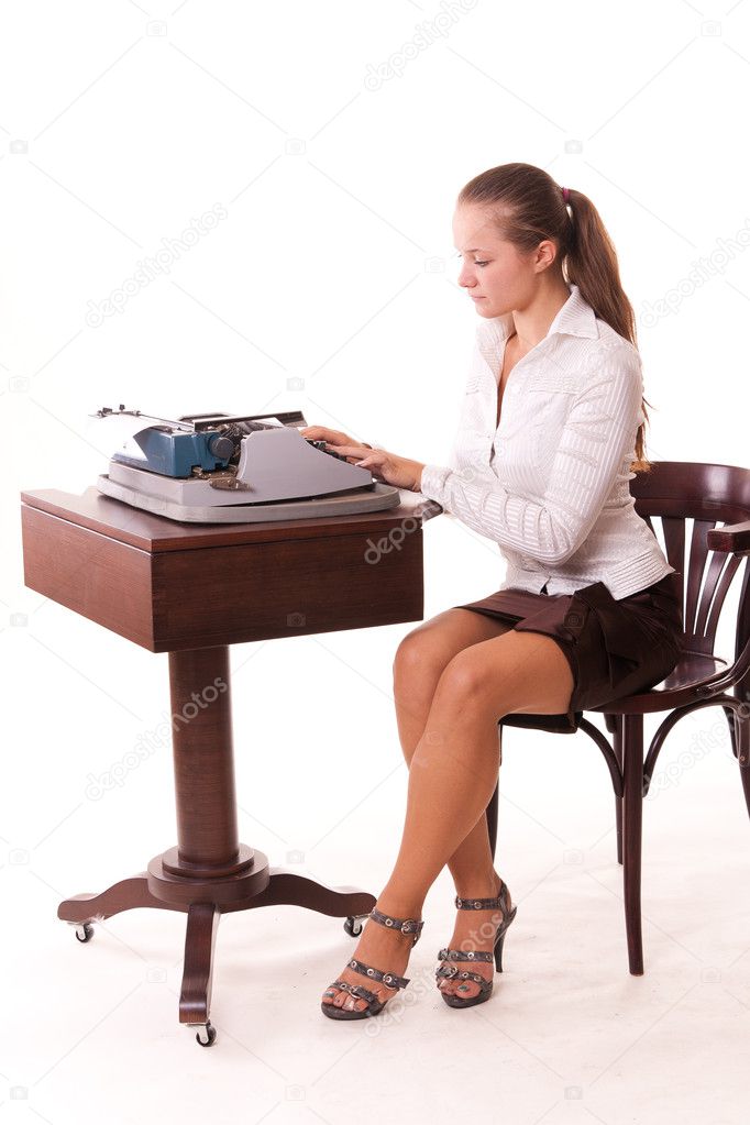 Young girl typing on old-fashion typewriter