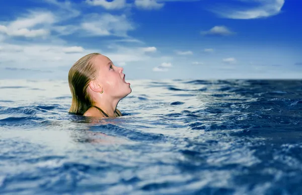 Cute preteen in the ocean looking up — Stock Photo, Image