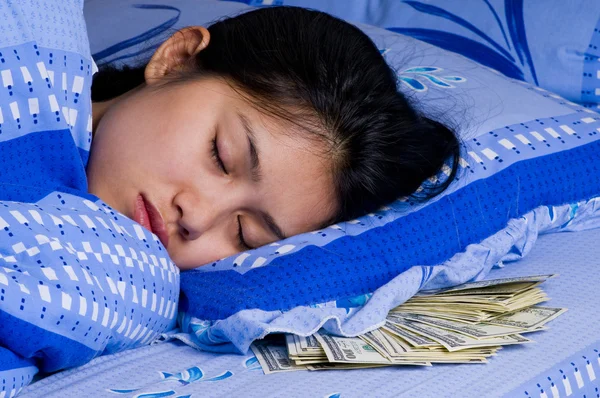 Woman with money under her pillow — Stock Photo, Image