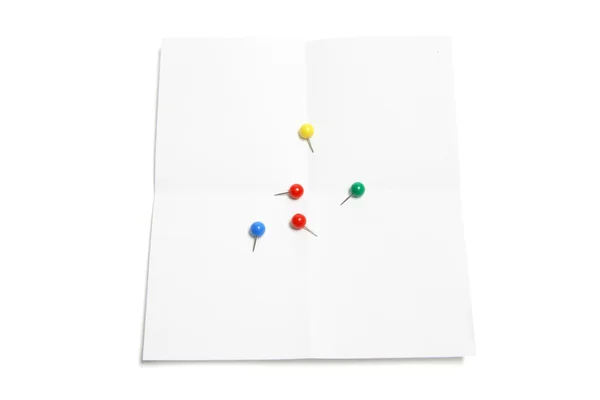 Pushpins sobre papel — Fotografia de Stock