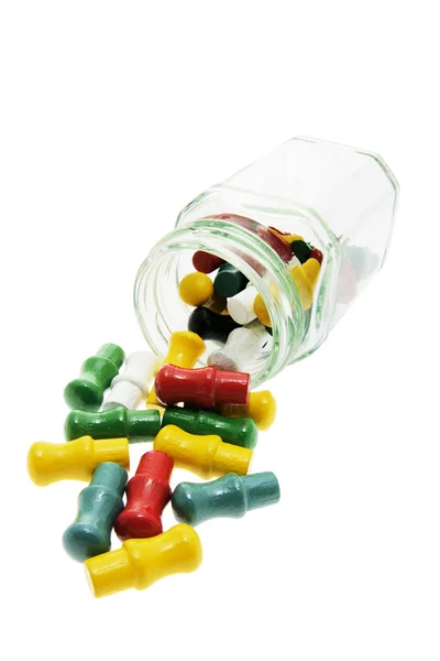 Game Pegs Spilling from Glass Jar — Stock Photo, Image