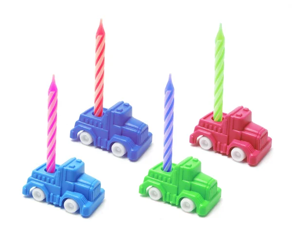 Carros de brinquedo com velas de aniversário — Fotografia de Stock