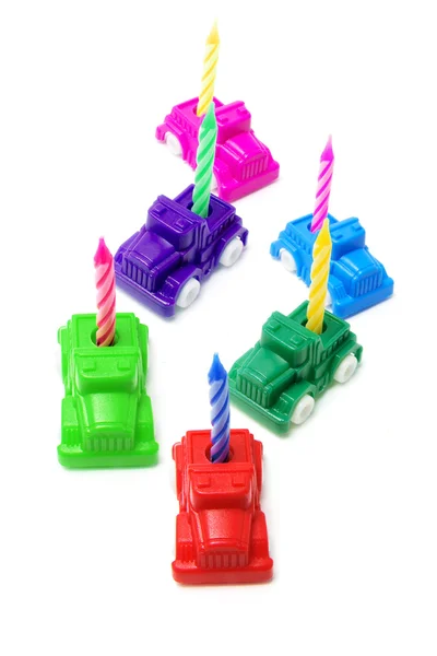 Carros de brinquedo com velas de aniversário — Fotografia de Stock