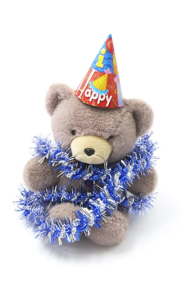 Urso de pelúcia com chapéu de festa e ouropel — Fotografia de Stock
